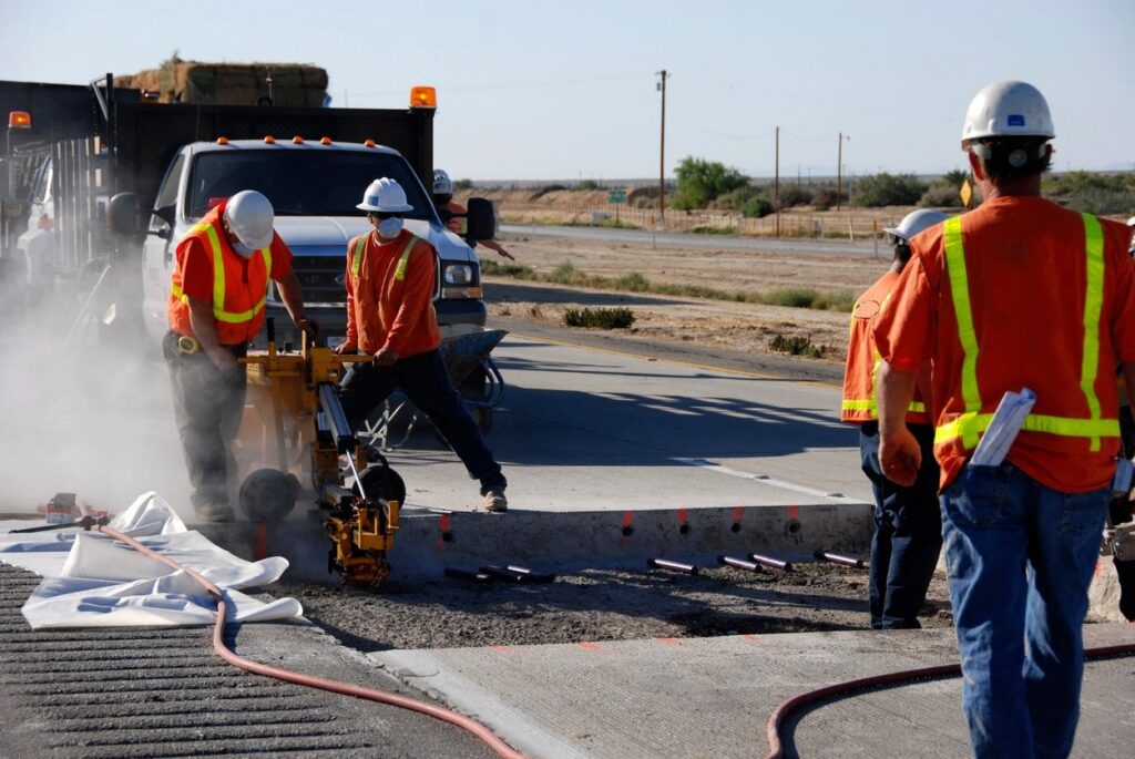 road construction crew - concrete maintenance services.